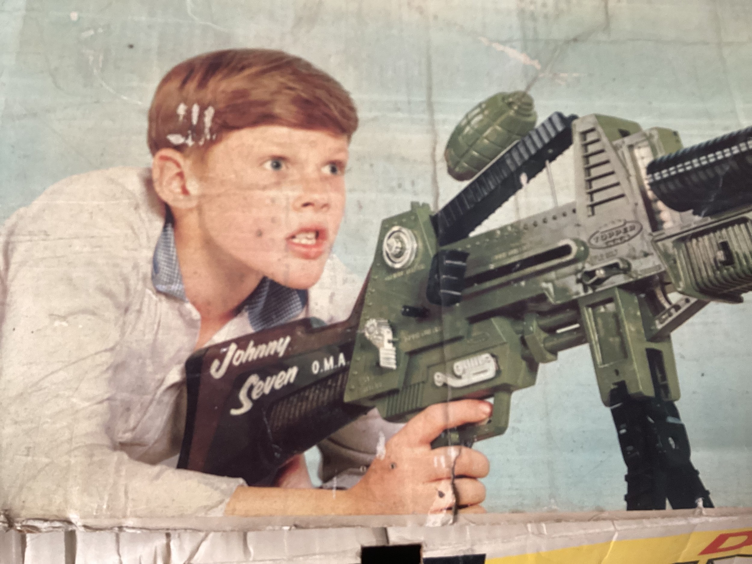 A Boxed Topper Toys Johnny Seven "OMA" One Man Army Rifle with gun with one Grenade, two different green armour piercing shell, one anti tank rocket and five white bullets, with good with general repairs, taped to corners etc