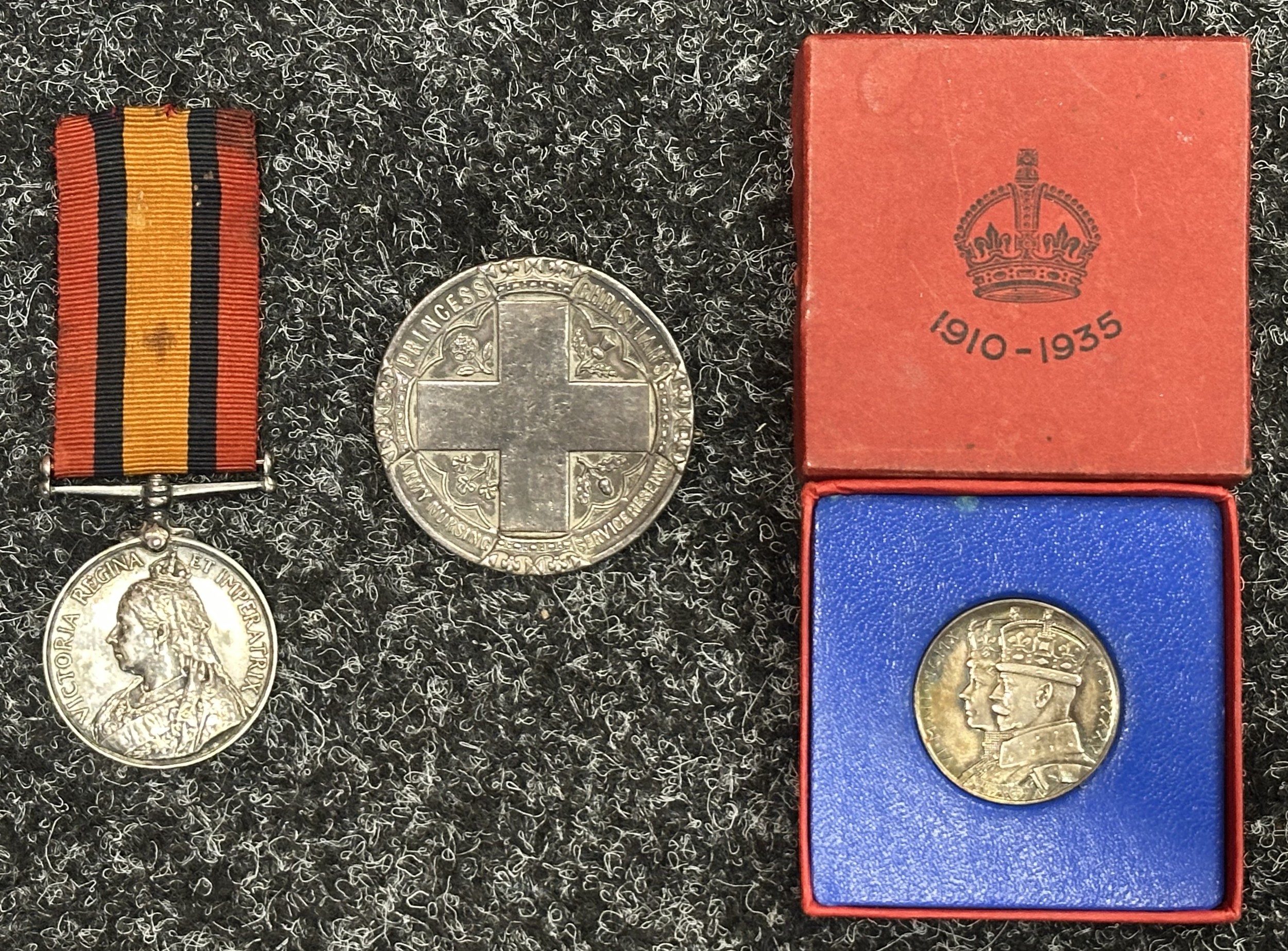 Boer War Queens South Africa Medal to Nursing Sister Mary Jane Spencer, complete with original ribbon without clasps. No clasps were awarded to Nurses. Along with rare silver Princess Christian's Army Nursing Service Reserve Membership Tippet badge serial number 690 and a boxed Geroge V Jubilee Medalion 1910-1935. Records show she was presented with her Medal by the King.