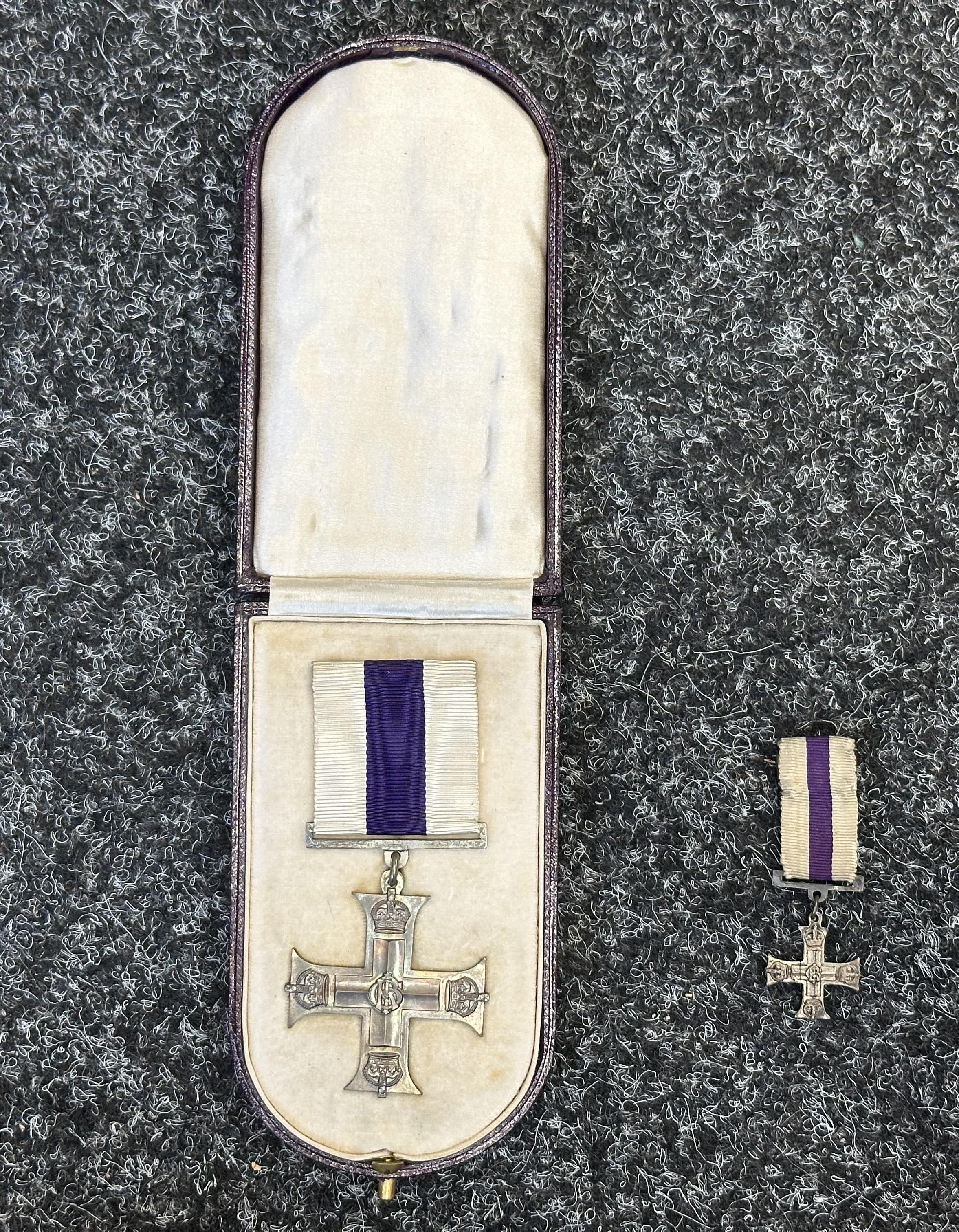 WW1 British Military Cross complete with ribbon with pin. No date to the reverse. Complete in case of issue. Together with a matching miniature Military Cross. (2)