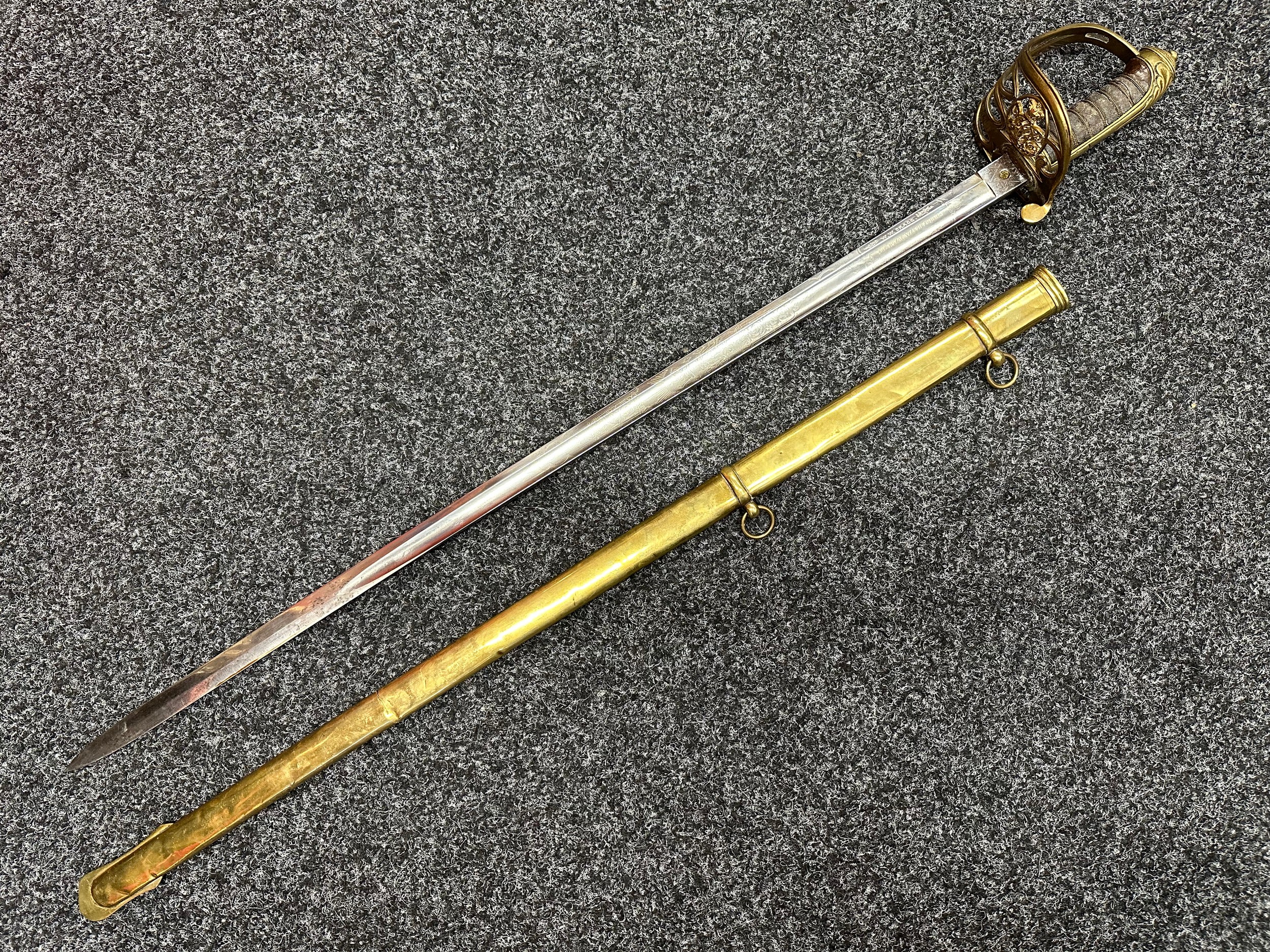 Victorian Officers Sword with single edged fullered blade 825mm in length with etched decoration of Queens Crown VR and dedicated to "WW Cragg, 4th Battalion The Royal Welsh Fusiliers", Proof Marked and Maker Marked "Webb & Bonella". Guard with Crown & VR. Wire bound Shagreen grip. Overall length 975mm. Complete with scabbard with twin suspension rings.