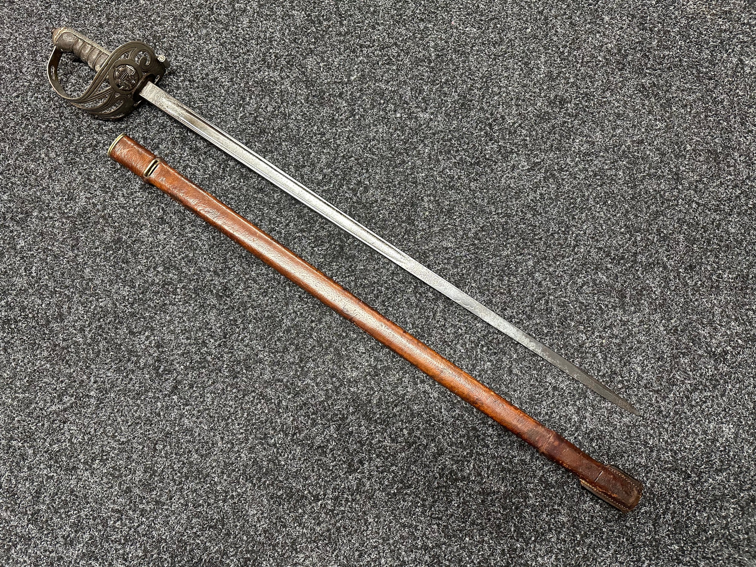 WW1 British Officers Presentation Sword with single edged fullered blade with etched dedication "Pro Honore, presented by the committee of the 16th Battn. Rifle Brigade (St. Pancras) to Major G Taylor MC24th May 1919", along with maker mark for "Henry Wilkinson, Pall Mall, London". Opposite side is Proof marked along with 16th Battn Rifle Brigade, GRV and Rifles Cap Badge. Spine of Blade numbered "56816". Blade length 810mm. Guard with Rifles Badge, wire bound Shagreen grip. Overall length 970mm. Complete with scabbard.