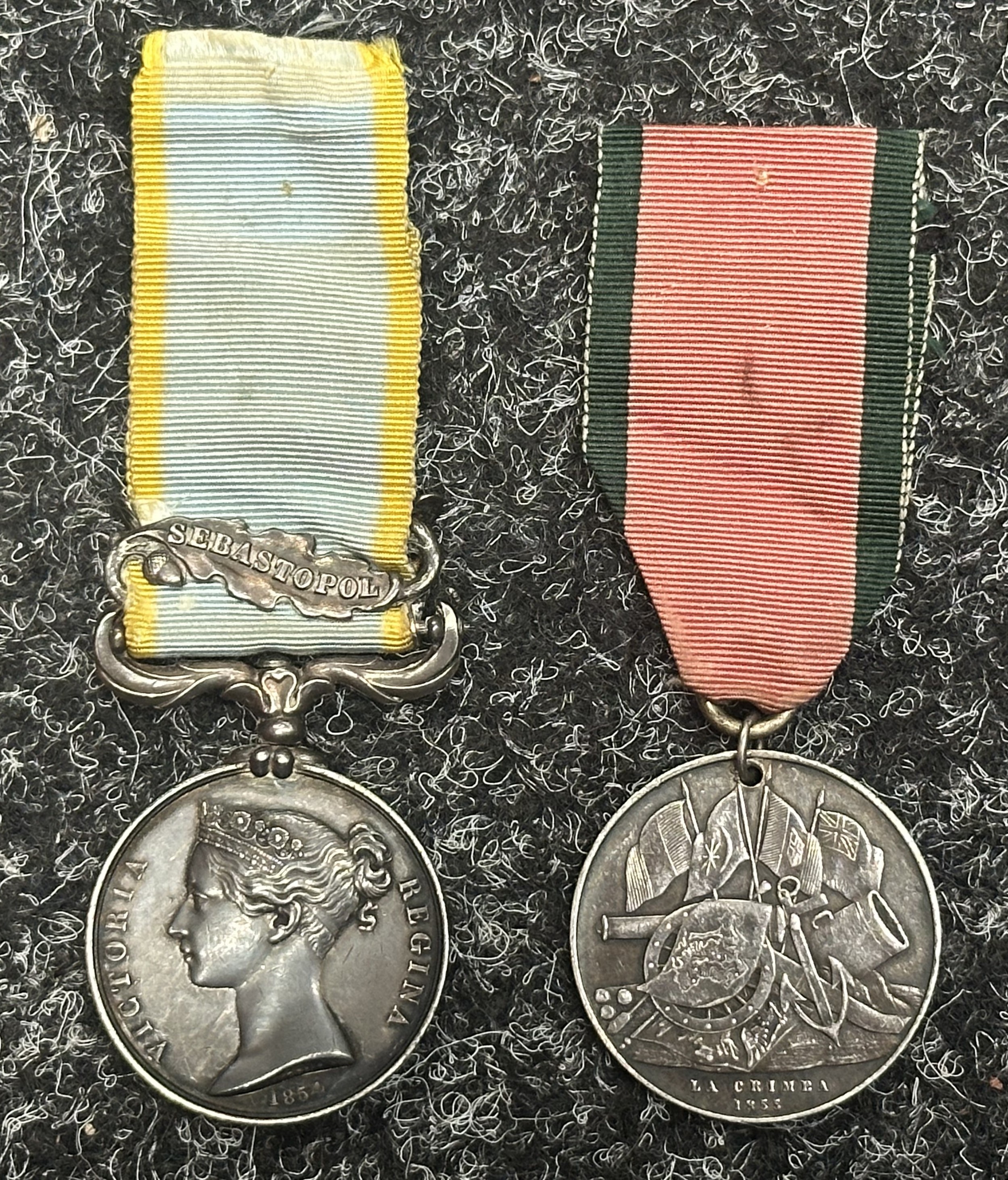 Victorian Crimea Medal Group comprising of: Crimea 1854 with Sebastopol Clasp engraved to "Surgn. L Langley MD, 62nd Foot". Complete with ribbon and in uncleaned condition. Along with his Turkish Crimea Medal, Sardinian issue engraved "W L Langley, Surgeon Major", complete with ribbon. Comes together with an extensive file of research. (2)