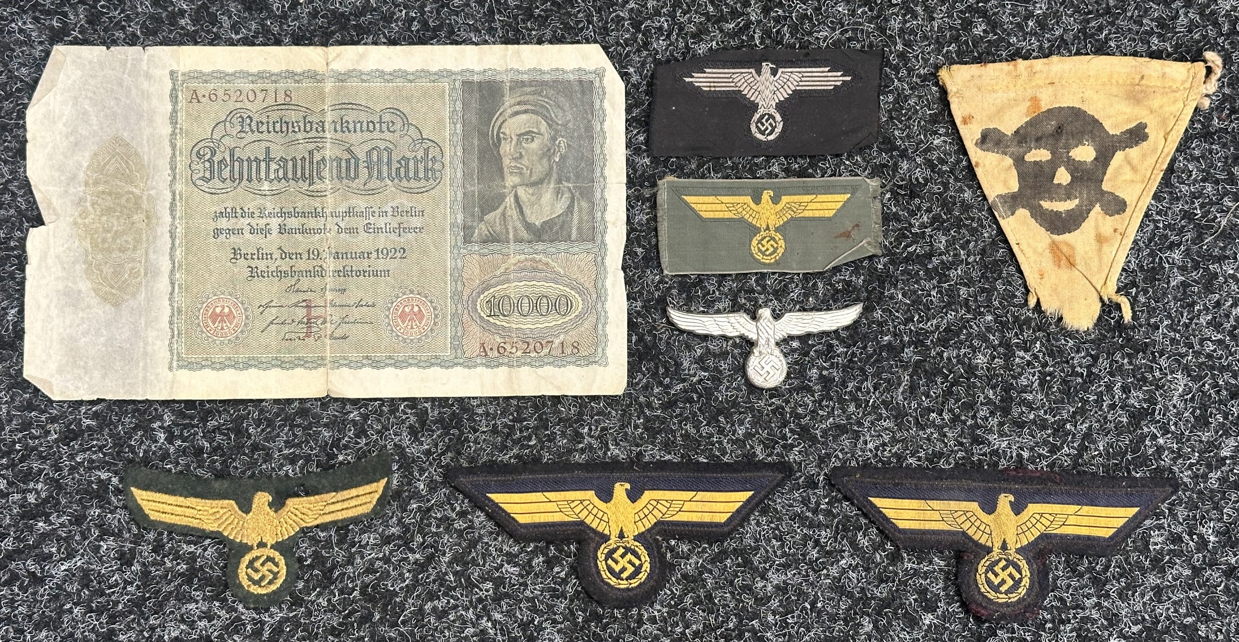 WW2 Third Reich Cloth insignia to include: uncut Bevo Waffen SS Feldmutze eagle, uncut Bevo Kriegsmarine Coastal Artillery cap eagle, uniform removed KM Coastal Artillery breast eagle, two uniform removed cut off KM Bevo breast eagles, Gas Warning/Minefield pennant, Zoll Customs officials cap eagle, no pins intact. Post WW1 Inflation money 10,000 Mark Banknote. All new to the market.