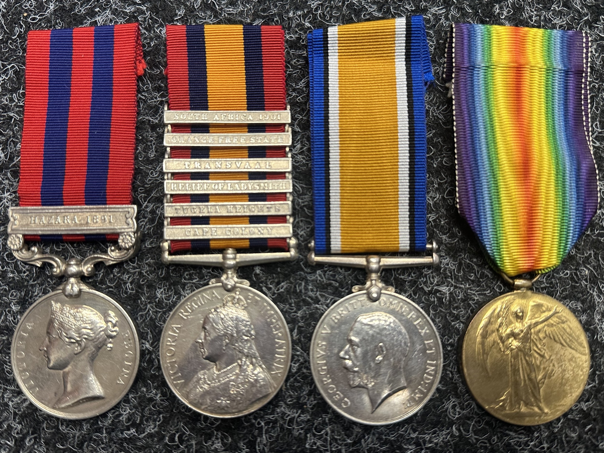Victorian / WW1 British Medal Group comprising of Indian General Service Medal 1854-95 with Hazara 1891 Clasp, Queens South Africa Medal with Cape Colony, Tugela Heights, Releif of Ladysmith, Transvaal, Orange Free State, South Africa 1901 Clasps, WW1 War Medal and Victory Medal to "13286 A WO Class 2, J Burridge, Royal Welsh Fusiliers". All complete with ribbons. Along with extensive research.