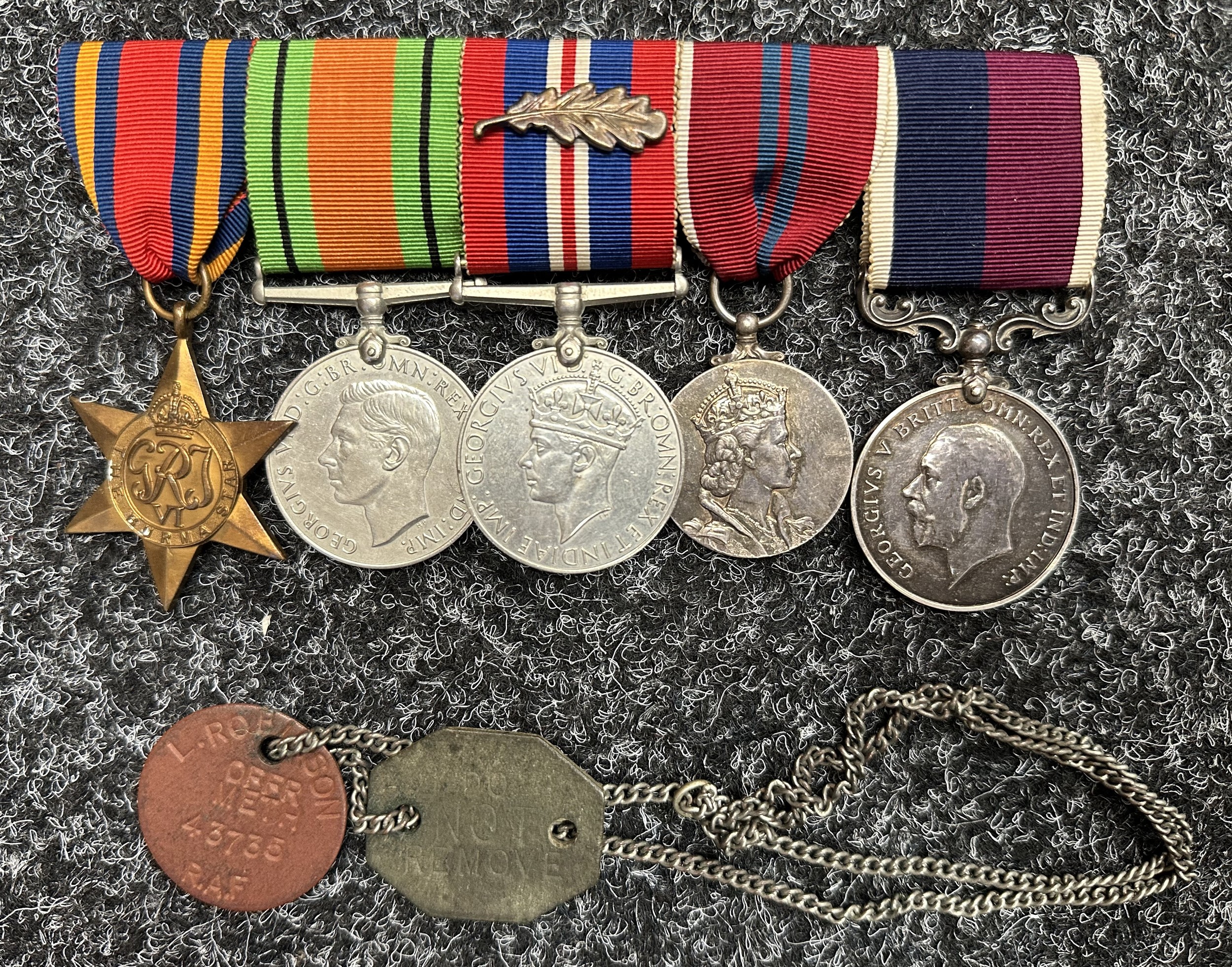 WW2 British RAF Medal Group to "43735 Flight Sgt L Robinson, RAF" comprising of Burma Star, Defence Medal, War Medal with Mentioned in Despatches Oakleaf, ERII Coronation Medal and RAF Long Service and Good Conduct Medal. All mounted on a bar and together with his identity dics on a chain.
