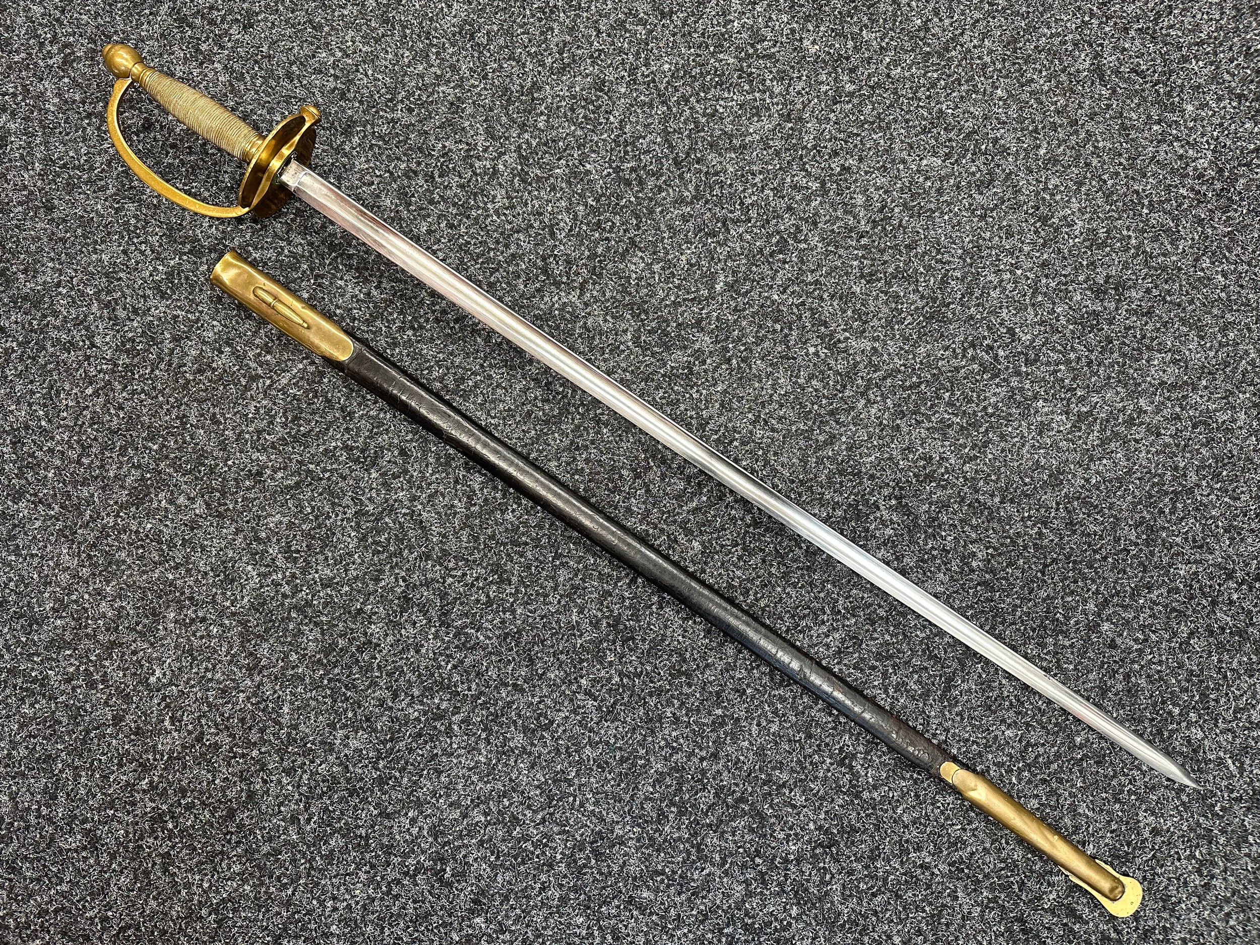 US Civil War 1840 Pattern NCO's Sword with single edged fullered blade 818mm in length, maker marked "Made by Ames Mfg.Co, Chicopee, Mass" along with "US 1864" plus inspectors mark "TKL". Remains of washer present. Brass guard, again inspection marked "JH". Overall length 985mm. Complete with leather scabbard with brass fittings and frog stud.