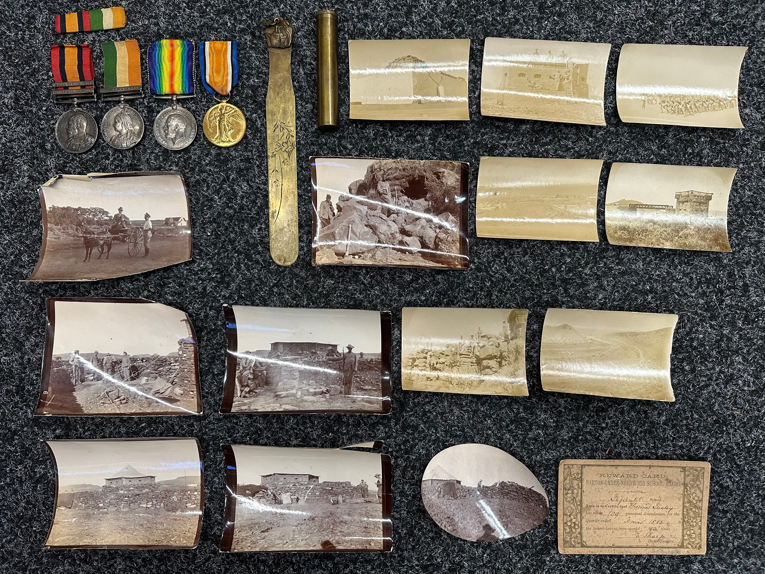 Boer War / WW1 Medal group comprising of: Queens South Africa Medal with Cape Colony Clasp, Kings South Africa Medal with South Africa 1901 and South Africa 1902 Clasps, named to "4788 Coprl T Insley, North Staffordshire Regiment" and his WW1 War Medal and Victory Medal named to "55156 Pte T Insley, Lincolnshire Regt". All complete with original ribbons. Along with privately taken photos of the Boer War, school report, plus a .303 Rifle Oil Bottle, etc. New to the market.