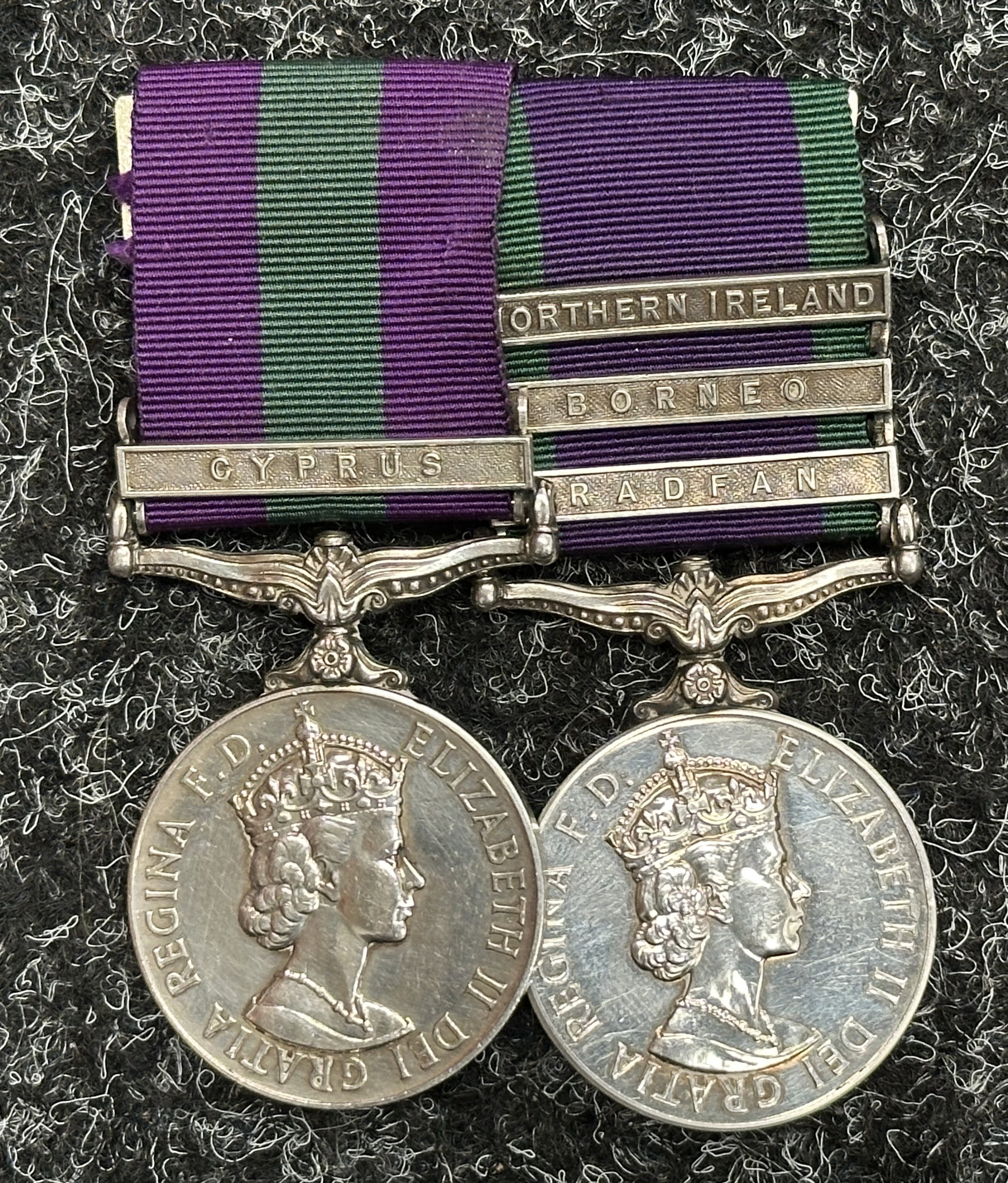 British ERII General Service Medal Group comprising of ERII GSM 1918-62 with Cyprus Clasp and ERII GSM 1962-2007 with Northern Ireland, Borneo and Radfan Clasps to "22548206 Cpl. EPE Swain, Royal Signals". Mounted on a bar.
