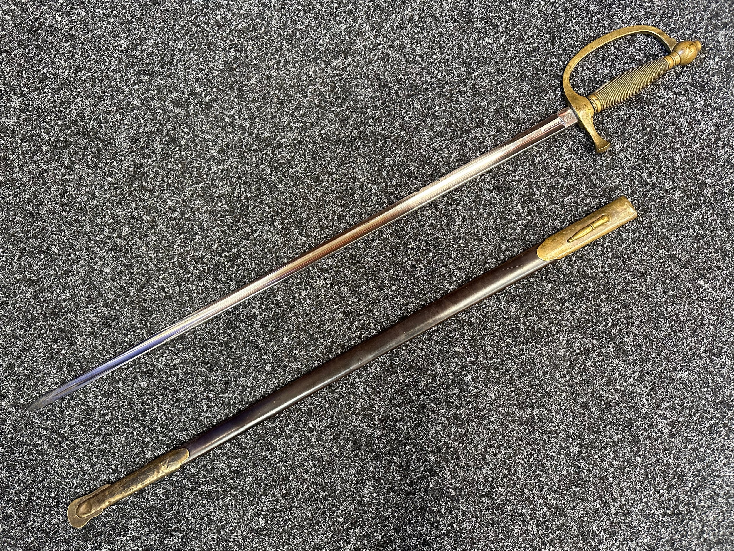 US Civil War Era M1840 Musicians Sword with fullered single edged blade 710mm in length, makers marked "Emerson & Silver, Trenton, NJ".Opposite side of blade is marked "US 1863". Also inspection marked "DFM" which stands for Dexter F. Mosman. Cast brass guard which is also inspection marked "DFM". Overall length 870mm. Complete with blued steel scabbard with brass fittings.