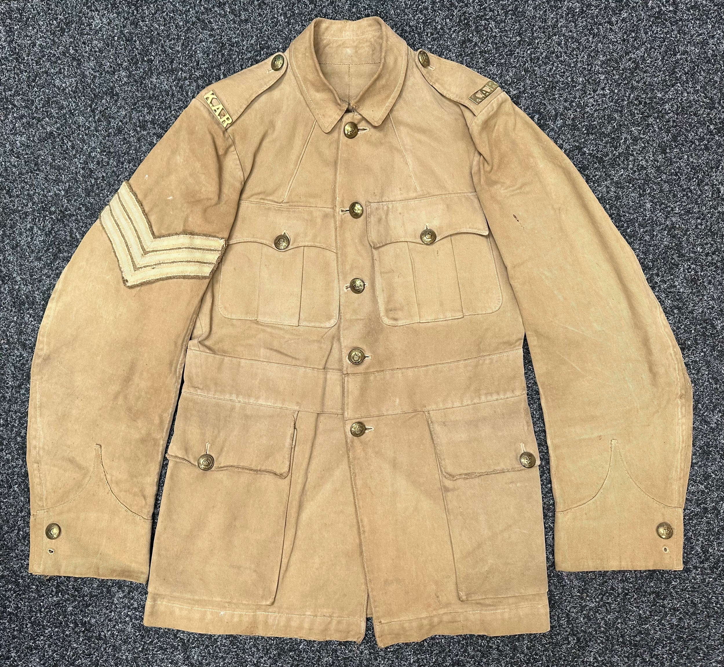 WW1 British Khaki Drill Tunic Sgt Kings African Rifles complete with original buttons, brass shoulder titles and Sgt's rank insignia to sleeve. Small size approx. 32 inch chest.