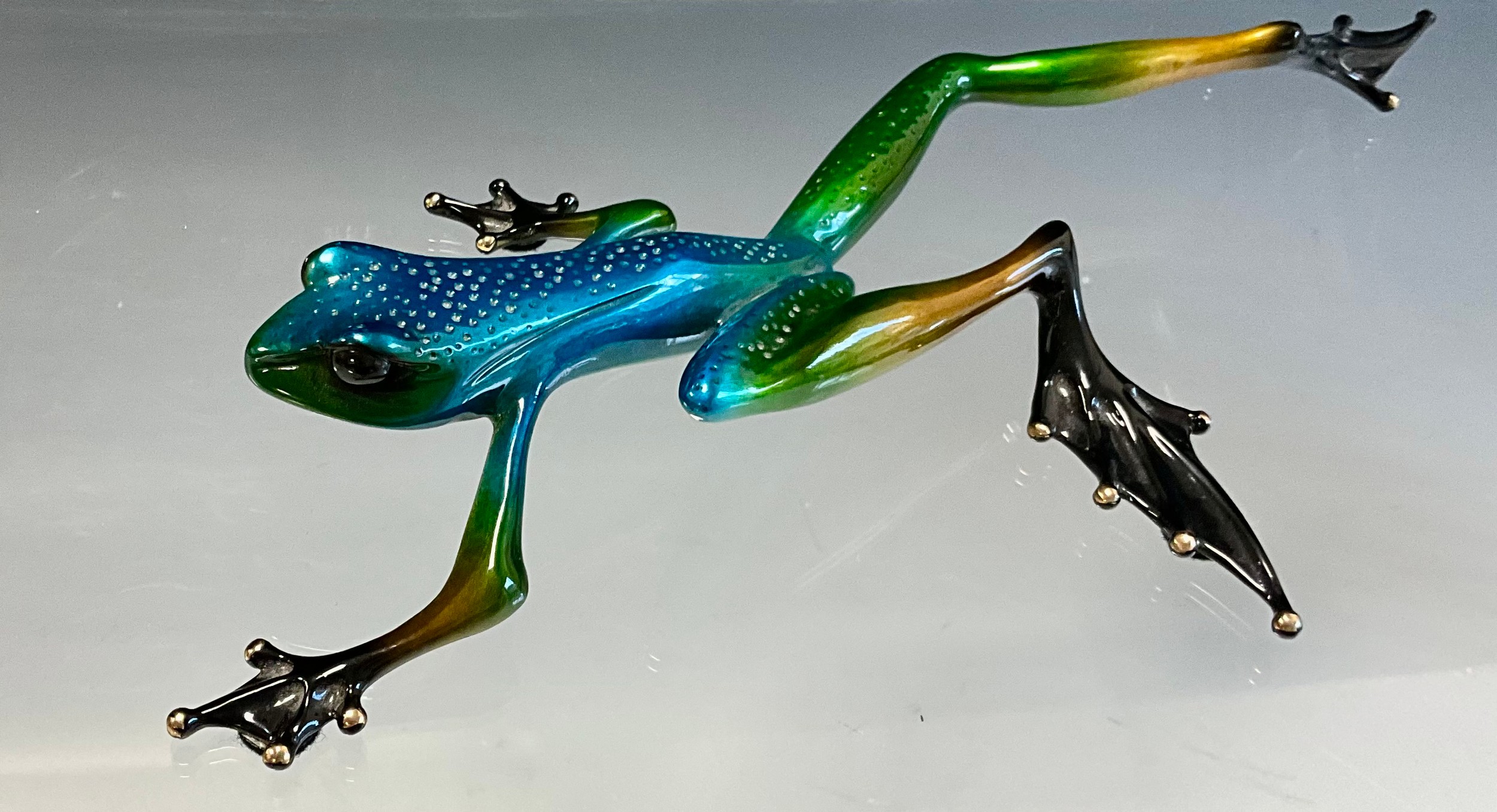 Tim 'Frogman' Cotterill; a limited edition lost wax cast bronze model 'Tango', of a Frog stalking with blue, green and black hue patina, limited edition numbered 297/500, signed and impressed marks, approx 29cm long, 15cm wide, with certificate Mulberry Hall, 28/03/08