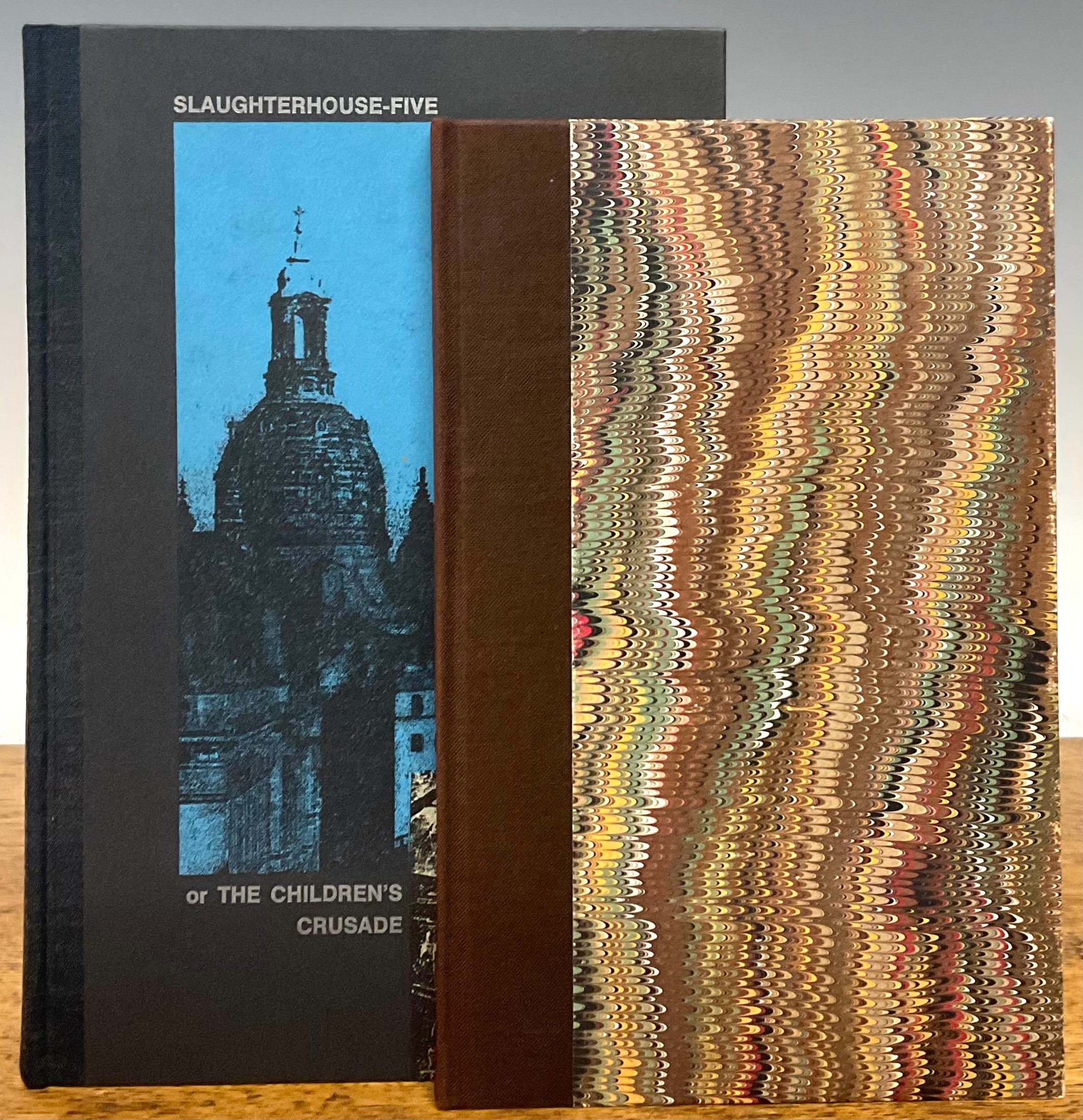 Vonnegut (Kurt, Jr., 1922-2007), Slaughterhouse Five or: The Children’s Crusade, A Duty Dance with Death, limited edn. 120/100, Cleveland, Hamilton Press, 2001 8vo, 191pp, plates illus. by Barry Hoffman, signed by illustrator, (pp.61-64 separated), maps to endpapers, pictorial covers on black boards by Karen D. Beckwith, grey titles to spine; Vonnegut (Kurt, Jr., 1922-2007), Nothing is Lost Save Honour, Two Essays, ltd. edn. no. 153/300, Jackson, Mi., Mississippi Civil Liberties Union, 1984, large 12mo, signed by the author, unpaginated on hand-cut paper, frontis. dwg., brown endpapers, brown cloth over marbled boards, gilt titles to spine (2)