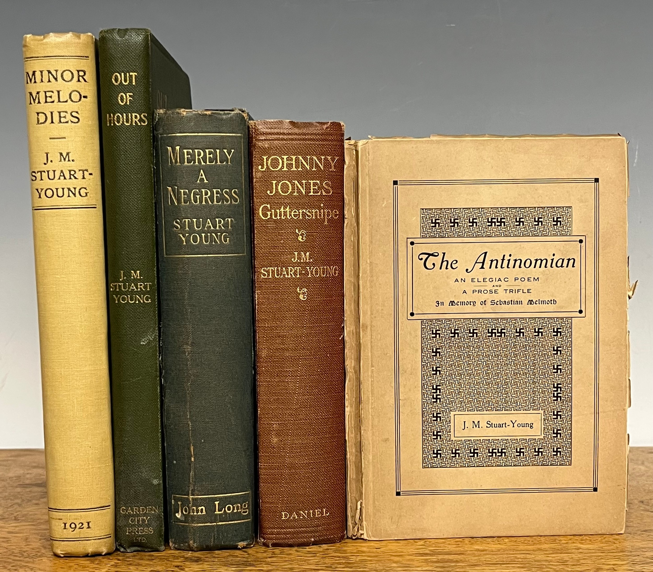 Books – Uranian interest: Works by J. M Stuart-Young (John Moray Stuart-Young, 1881-1939): The Antinomian, 3rd printing, London, Hermes Press, 1909 12mo, 61pp, printed card covers; Johnny Jones, Guttersnipe, 1st edn., London, C. W. Daniel, 1926 8vo, 320pp, bound red cloth, gilt titles to spine (spine a little rolled); Merely a Negress: a West African Story 1st edn., London, John Long, 1904, 8vo, 340pp, uncut lower edges, bound blue cloth, gilt titles to spine (spine worn, faded & creased); Minor Melodies, 1st edn., Edinburgh, T & A Constable, privately printed, 1921, royal 8vo, xxx + 247pp, top edges grey/blue, other edges uncut, decorated endpapers, black printed cream boards (bumped) and to spine (chipped, torn and faded d. w. tucked inside front board); Out of Hours: Poems, Lyrics and Sonnets, 1st edn., London, Arthur Stockwell 1909, 8vo, 112pp uncut, frontis photograph of author, tissue guard, one other plate, gilt embossed green cloth, gilt titles to spine (5)