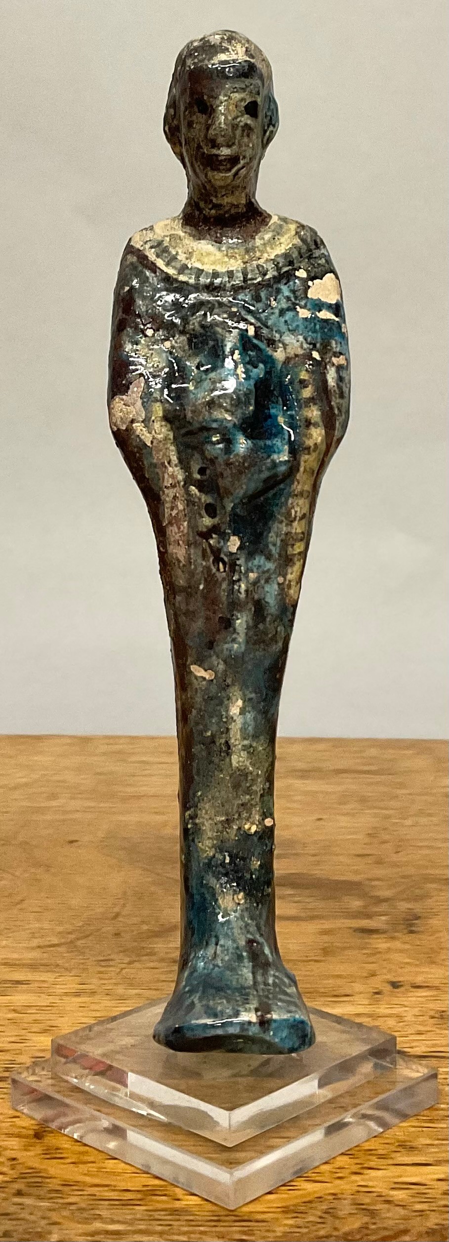 An Egyptian shabti, partial lustrous glaze, 17cm high, mounted for display