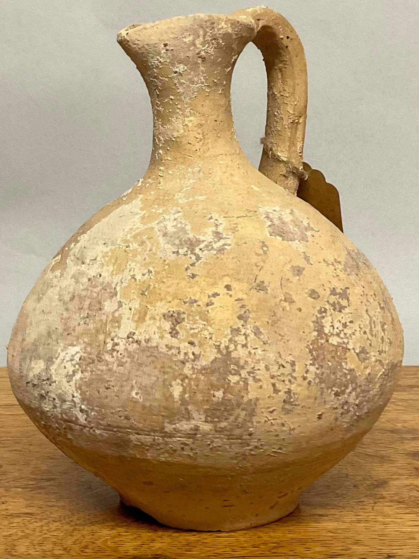 An earthenware oinchoe wine vessel, of typical Greco-Roman  design, 19cm high