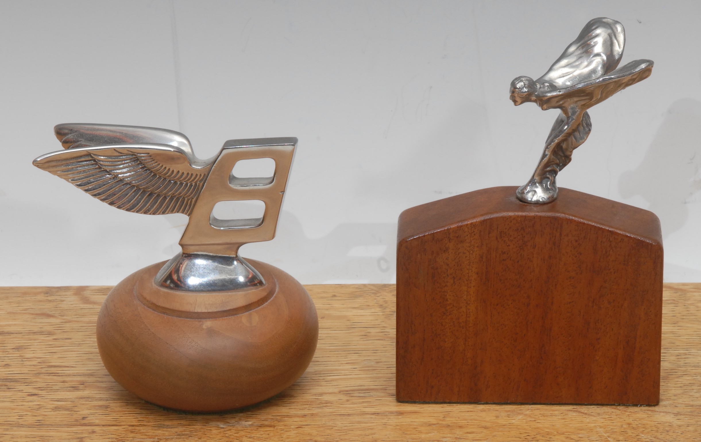 A chrome plated Bentley car mascot, mounted for display, 10cm high overall; another, Rolls Royce, Spirit of Ecstasy, after Charles Robinson Sykes (1875-1950), 13cm high overall (2)