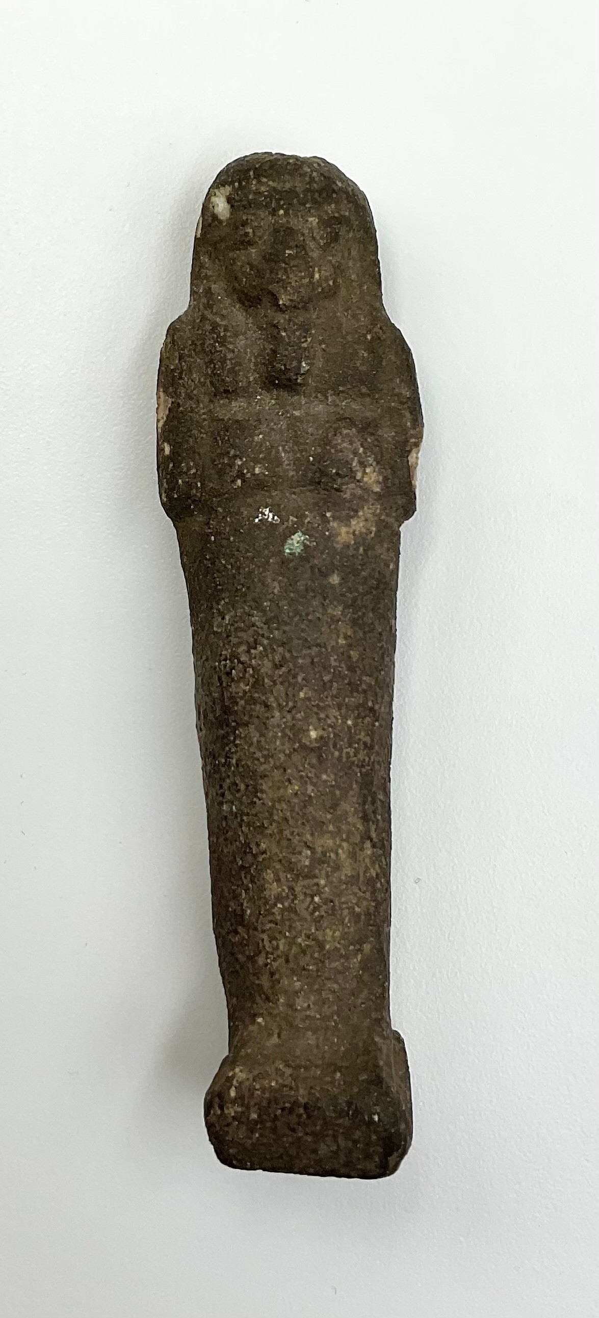 An Egyptian shabti figure, traces of turquoise glaze, 8cm high