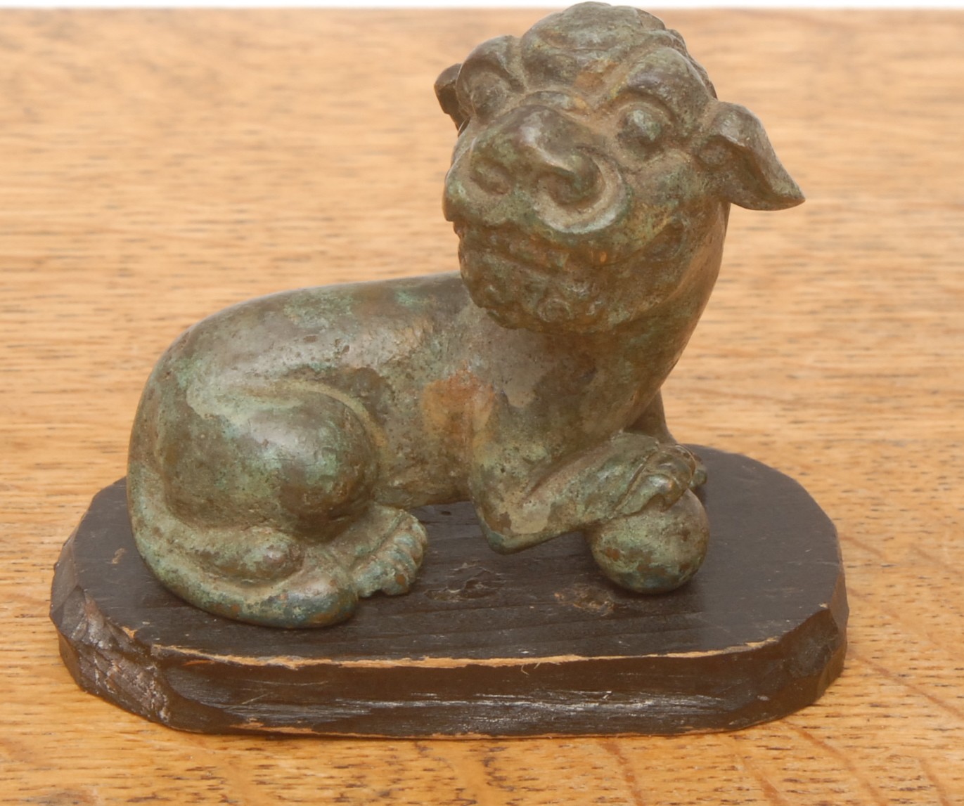 A Chinese verdigris cabinet bronze, of a Fu or temple dog, in the antique manner, ebonised plinth base, 7cm high overall, 7cm long