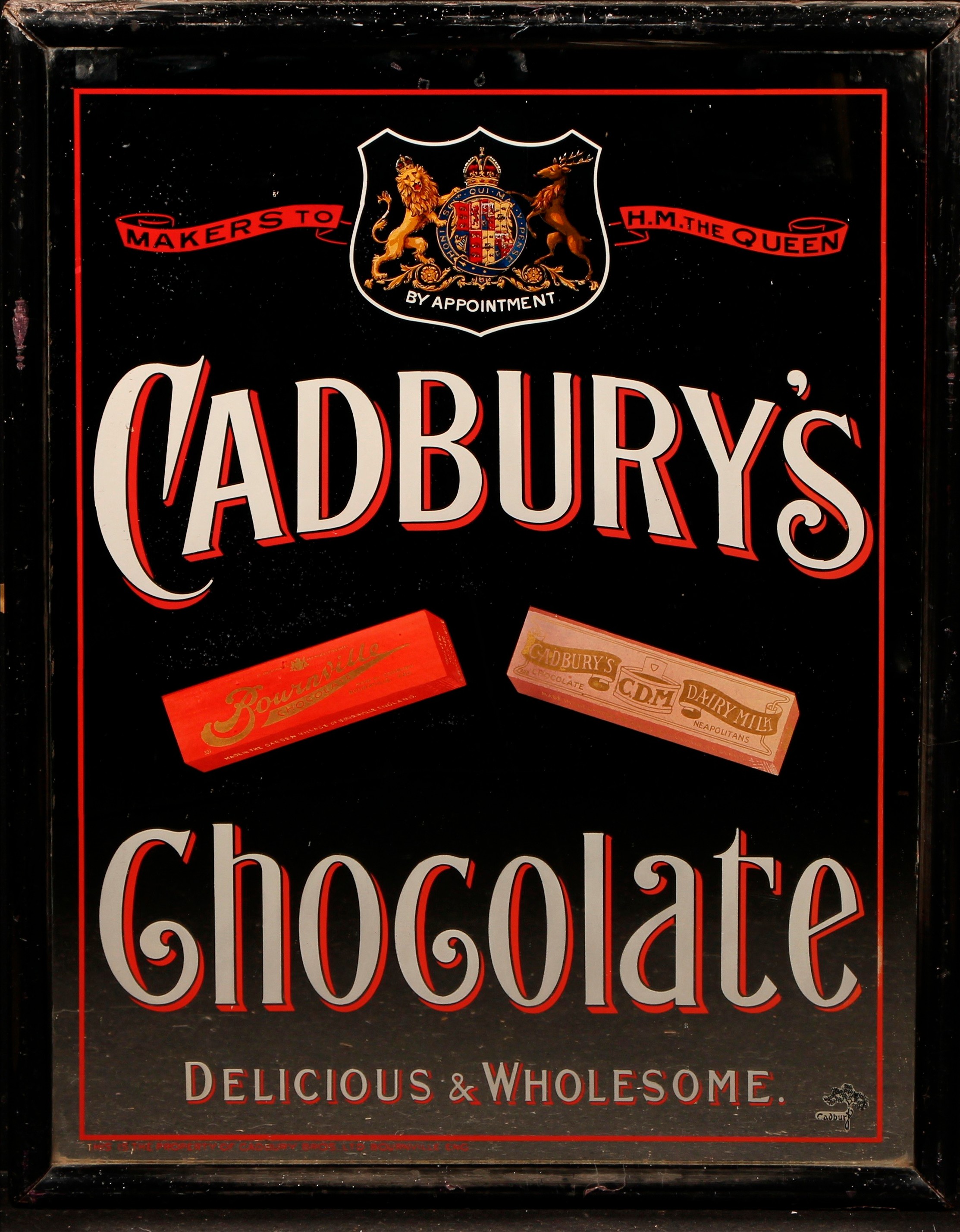 Advertising - Confectionery - a Victorian rectangular pictorial mirror or sign, Cadbury's Chocolate, Delicious & Wholesome, Makers to H.M. The Queen, illustrated with two labelled bars, ebonised frame, 70.5cm x 55cm overall