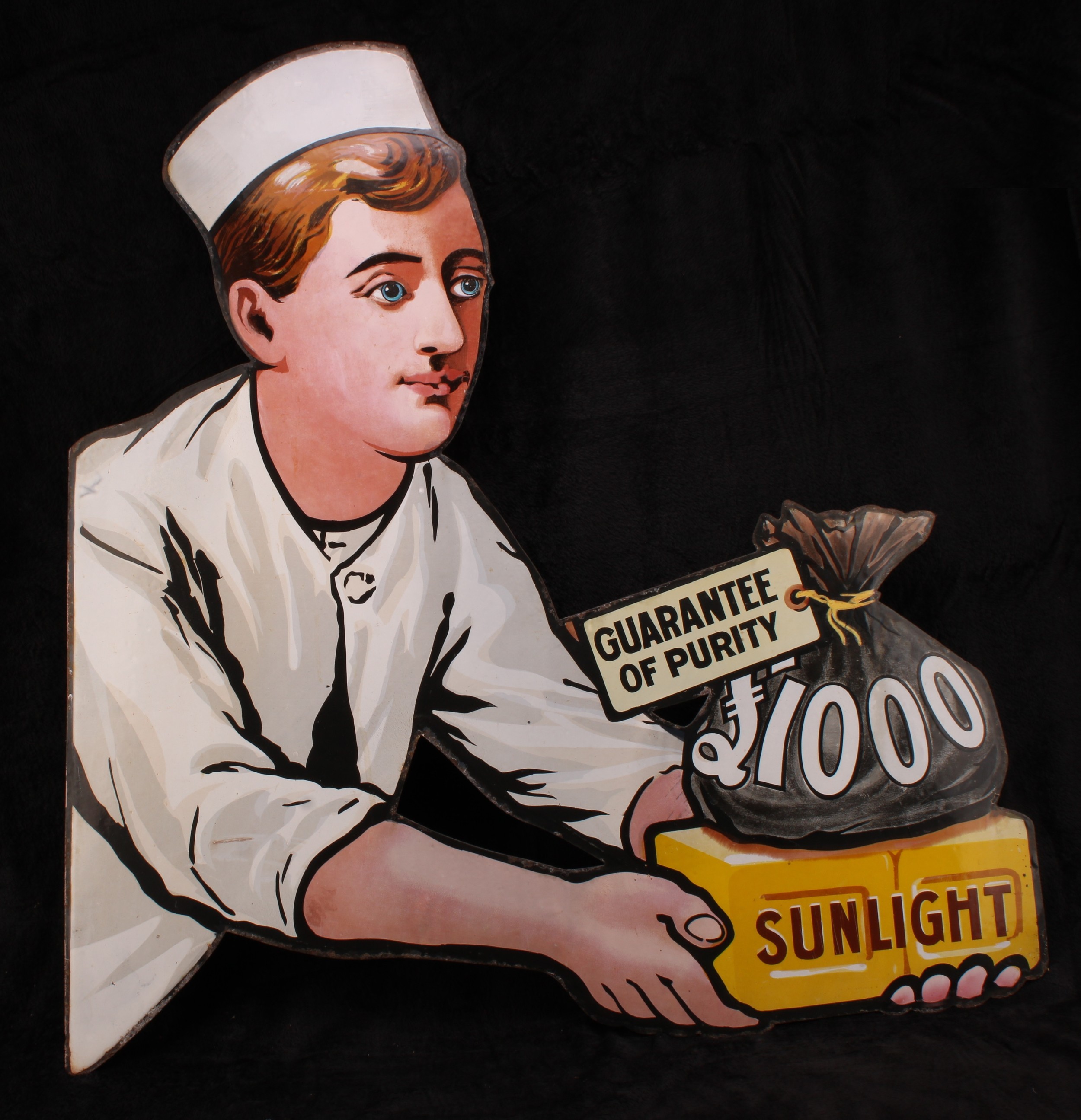 Advertising - an early 20th century shaped pictorial enamel sign, Sunlight, £1000 Guarantee of Purity, cut-out and illustrated with a 'Baker Boy', 86cm x 82cm