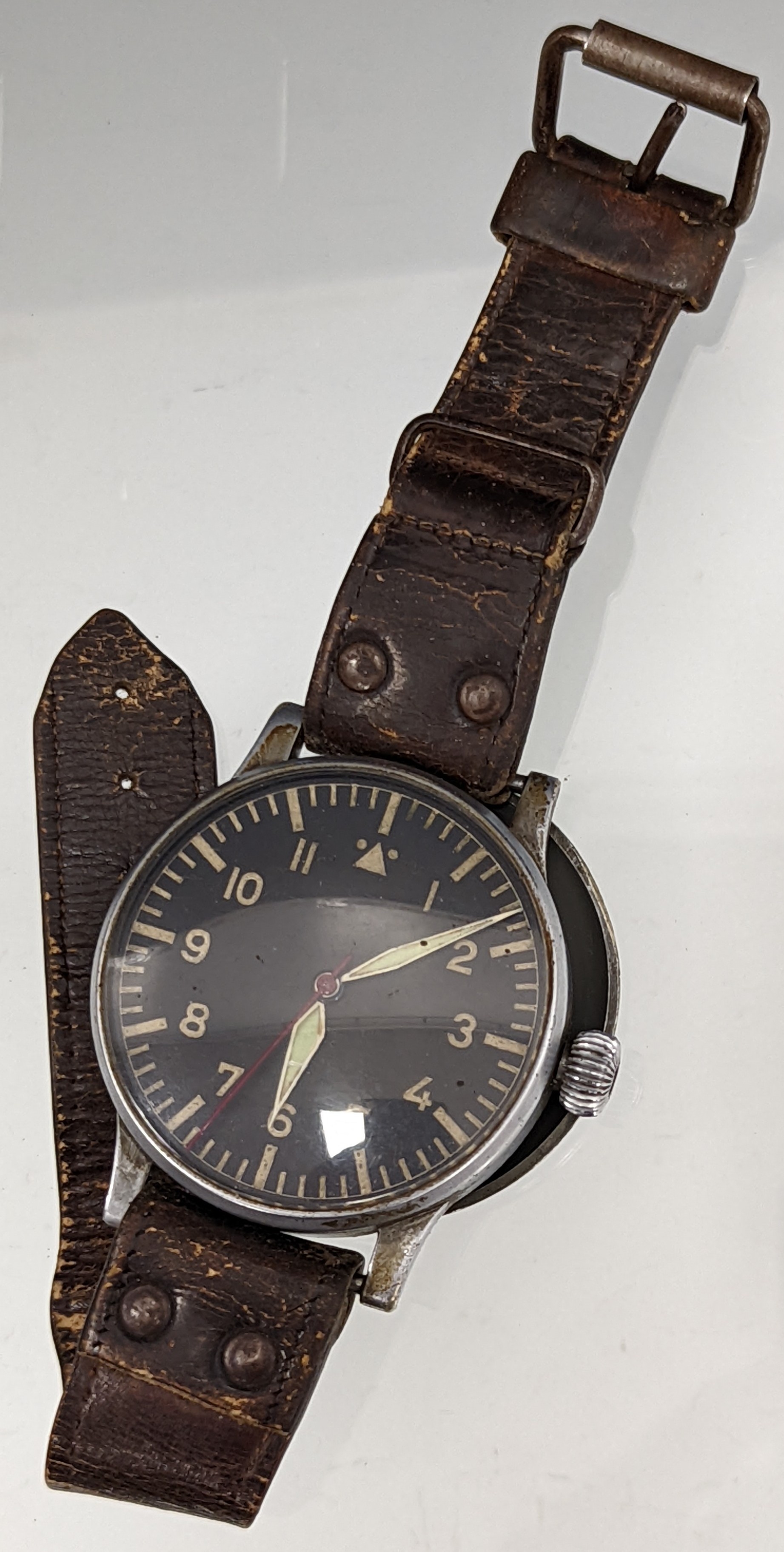 A Rare WWII German Military Luftwaffe B.UHR A. Navigators Observation watch by Wempe, ref. FI 23883, the black dial with outer minute indices, inner Arabic hour numerals, with steeled luminous sword hands and hacking seconds, oversized onion crown, gilt frosted signed movement, no. K 31, nickel case with fixed bar lugs, the inside case back marked 'B-uhr, Bauart : Thommen, Gerat Nr 127-560A-1, Werk-Nr BLT 1329, Anforderz FI. 23883, Hersteller: Wempe Hamburg, case 55mm diameter, numbered 1329 to verso, brown leather strap, c.1943